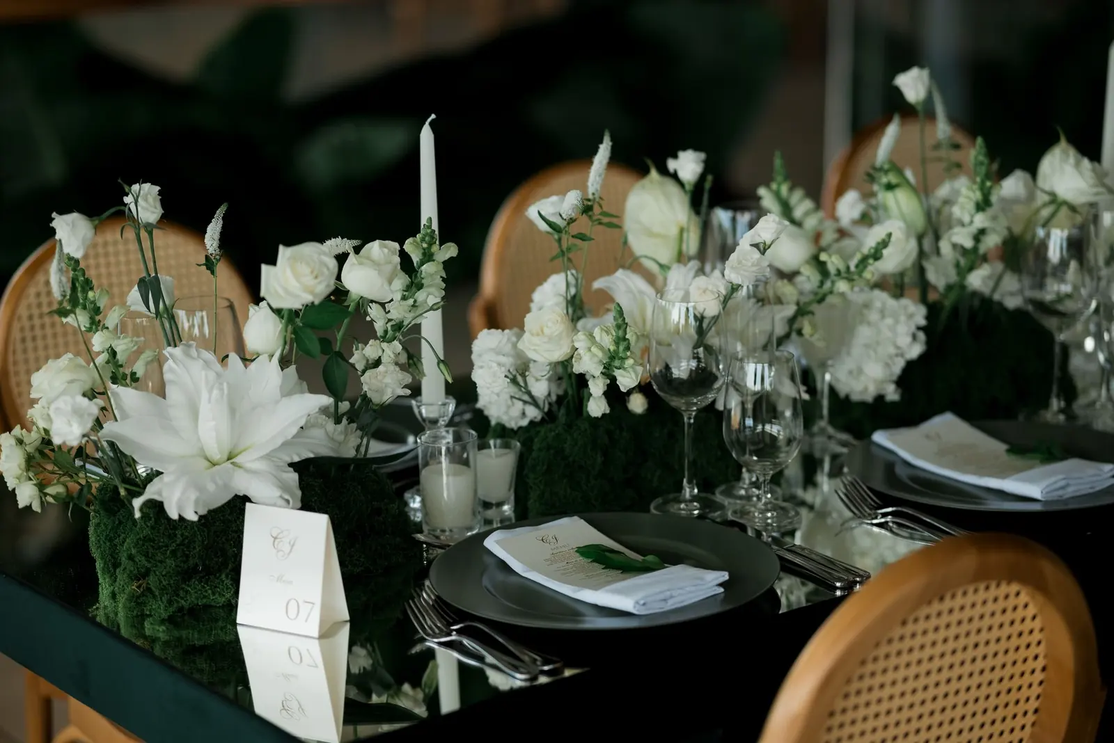Elegant wedding reception table with white flowers and glassware
